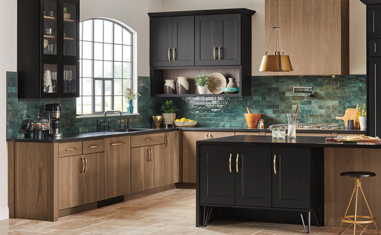 green tile backsplash in a kitchen with brown and black cabinetry