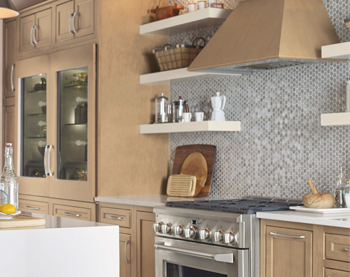 Mosaic hexagonal tile backsplash in a kitchen behind a stove
