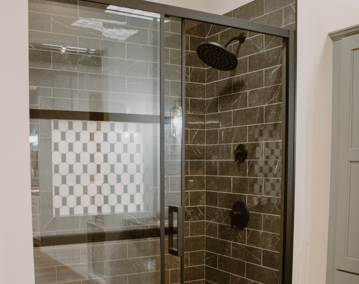 Gray wall tile on a shower wall with freestanding tub