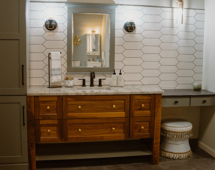 Green cabinets and natural wood vanity in a bathroom